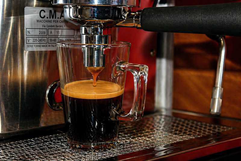 Rooibos Espresso läuft aus einer Espressomaschine in ein Glas