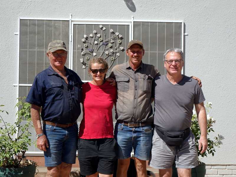 Group photo in front of the farmhouse: Mr Rossouw, Herma Schoeman with her husband, and the visitor.