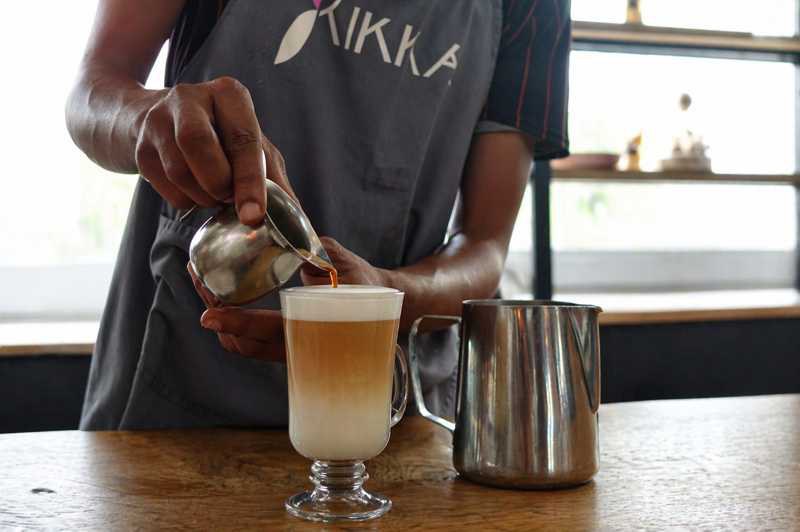 Rooibos Espresso being poured into a milk drink in a café