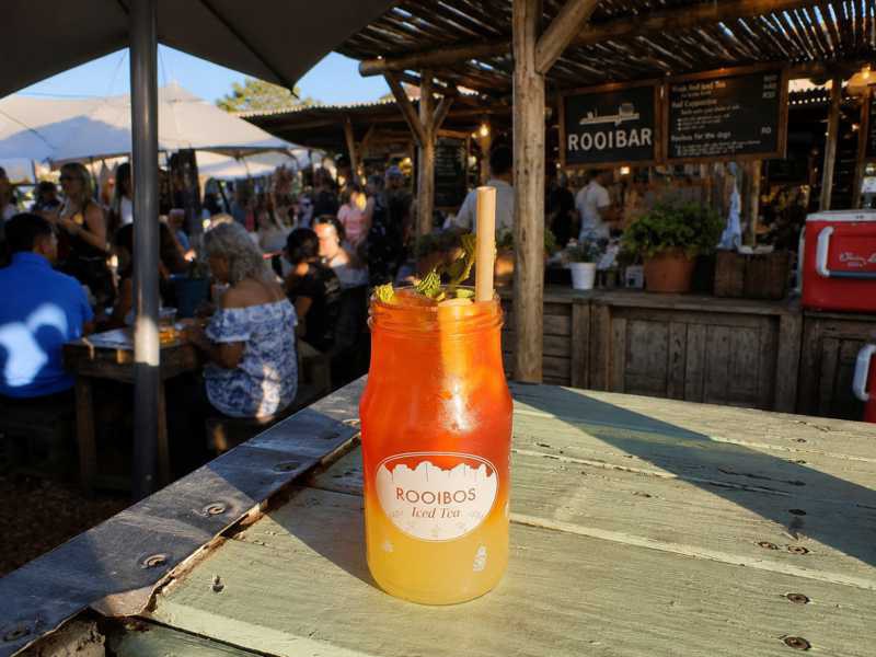 Rooibos iced tea in a glass with mint and a straw at the Oranjezicht Market in Cape Town
