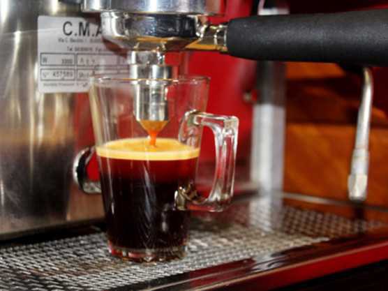 Rooibos espresso extraction from a portafilter into a glass